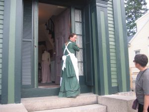 Lee=ann Wilber demonstrating the shutters for the glass panes at the front door