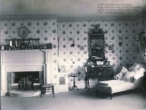 Effie Borden’s room.  Note the family photographs adorning the mantle and the English style furniture in contrast to the modern looking wall to wall rug. Courtesy of the Fall River Historical Society.